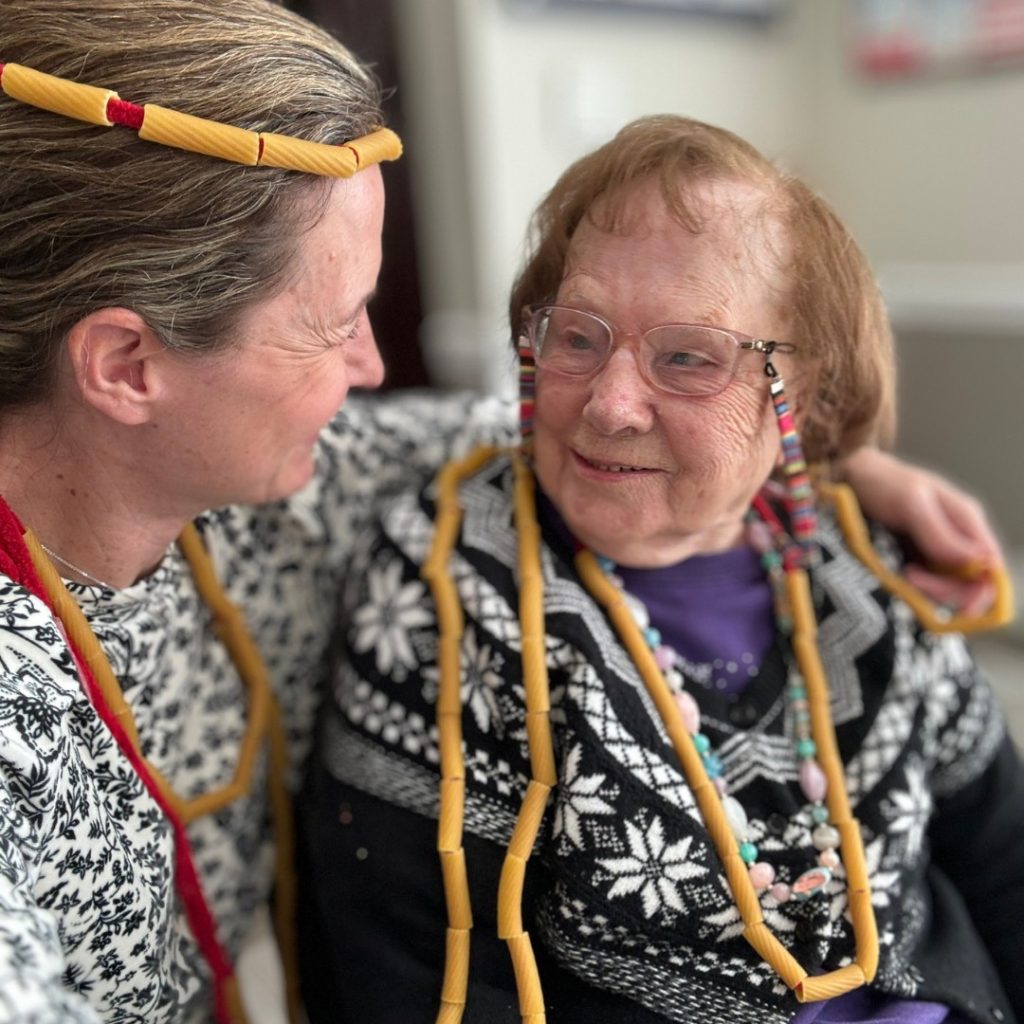 Female memory care resident receiving a warming hug.