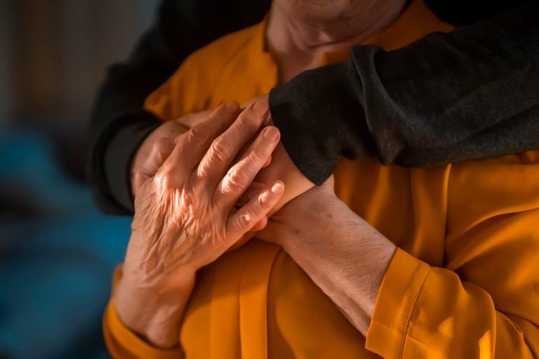 Alzheimer's patient in memory care community being consoled by family member