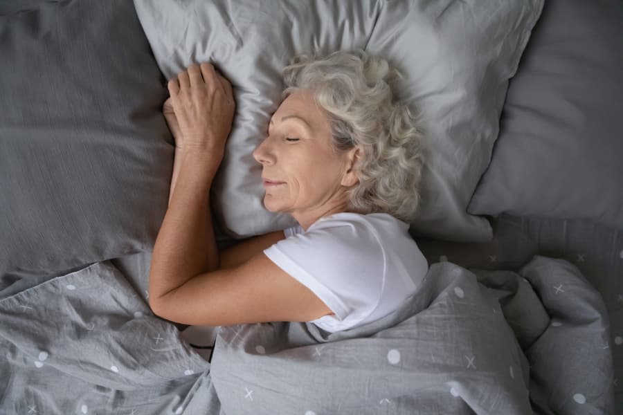 Elderly woman sleeping comfortably in bed